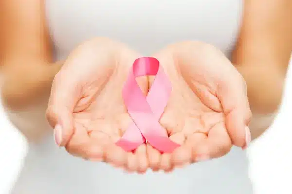 depositphotos 35349215 stock photo hands holding pink breast cancer